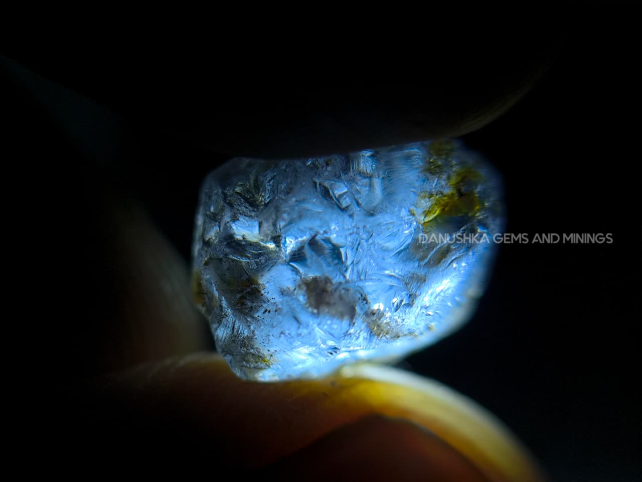 Three-piece facet-grade Spinel rough parcel with color-change, purplish pink, and blue Spinel stones showing natural inclusions and cutting potential.