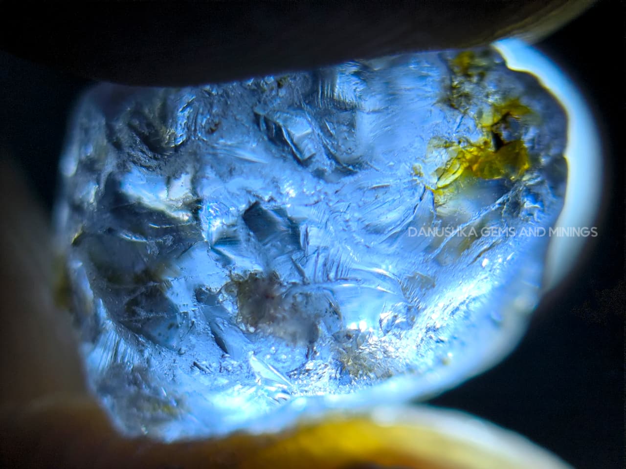 Three-piece facet-grade Spinel rough parcel with color-change, purplish pink, and blue Spinel stones showing natural inclusions and cutting potential.
