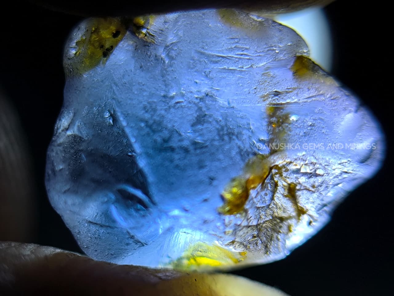 Three-piece facet-grade Spinel rough parcel with color-change, purplish pink, and blue Spinel stones showing natural inclusions and cutting potential.